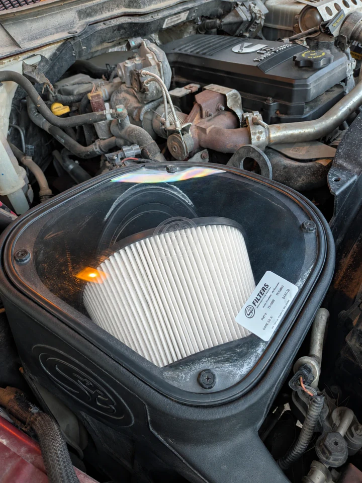 An S&B cold air intake installed in a diesel engine bay